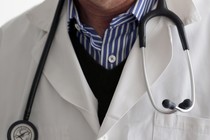 A photo-illustration shows a French general practitioner with a stethoscope in a doctor's office in 2015.