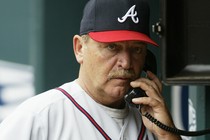 Leo Mazzone using a dugout phone