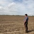 A soybean farmer looks out at his field in Wilton, Iowa.