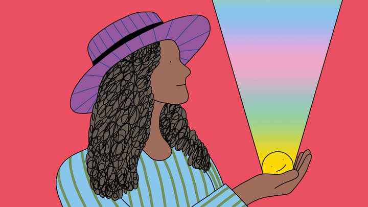 A woman stands holding a smiley face in her palm; a rainbow beam of light emanates from the smiley face to the heavens.