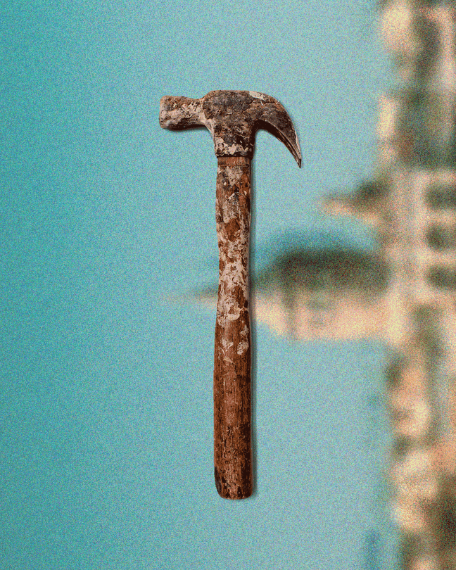 A hammer against a blurred landscape background