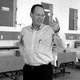 The humanitarian Paul Farmer standing up and smiling