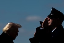 An image of America military personnel saluting President Trump.