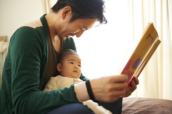 father reading to his baby son