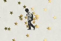 Young boy drags his foot in front of background of gold stars