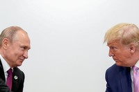 Trump and Putin smiling at each other
