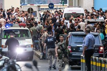 Crowds and confusion gather around ambulances in Beirut.