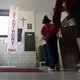 Students at a Catholic school pass a statue of the Virgin Mary and a crucifix on their way to class. 