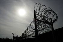 A rusting fence with barbed wire