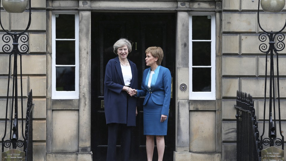 Scotland's First Minister, Nicola Sturgeon, greets Britain's new Prime Minister, Theresa May, as she arrives at Bute House in Edinburgh, Scotland, on July 15, 2016.