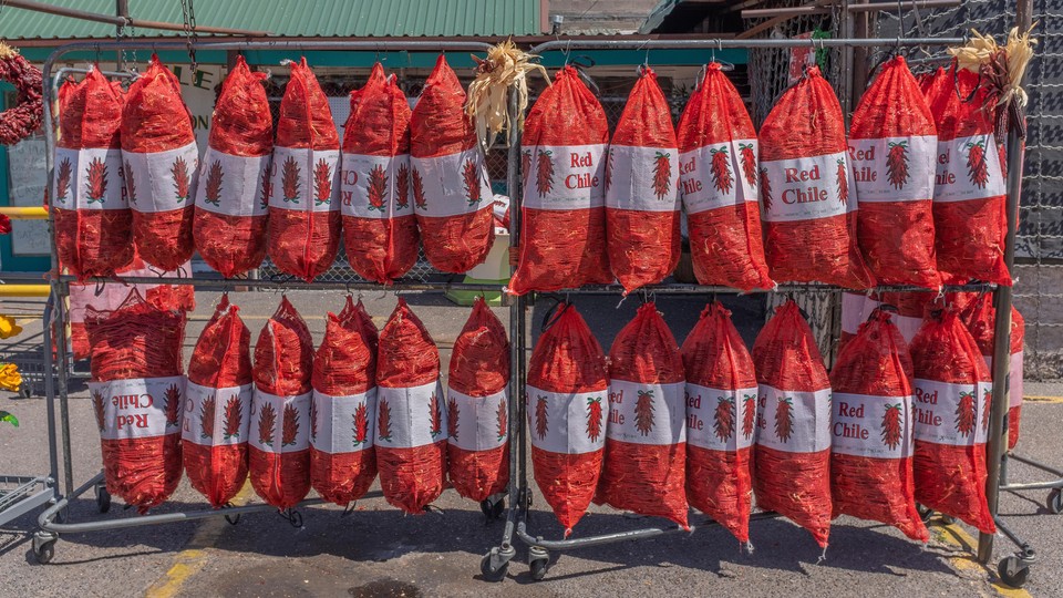 Bags of chile peppers hanging on a rack