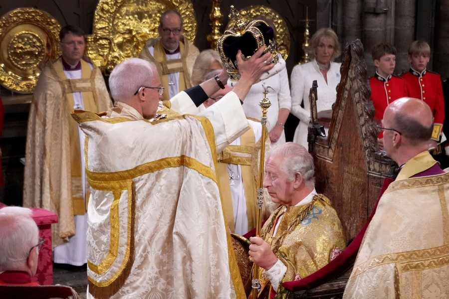 An archbishop places a crown on King Charles's head.