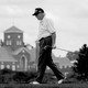 Donald Trump walks holding a golf club at his Bedminster golf club