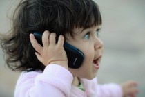 a small girl talking on a phone