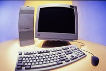A digital computer with monitor, keyboard, tower, and mouse on yellow and blue background