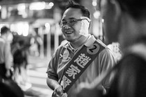 Pro-democracy district-council candidate Andrew Chiu, who was attacked by a man who bit off part of his ear in early November, canvasses on the street during the district council elections in Tai Koo Shing District Council in Hong Kong on November 24, 2019.