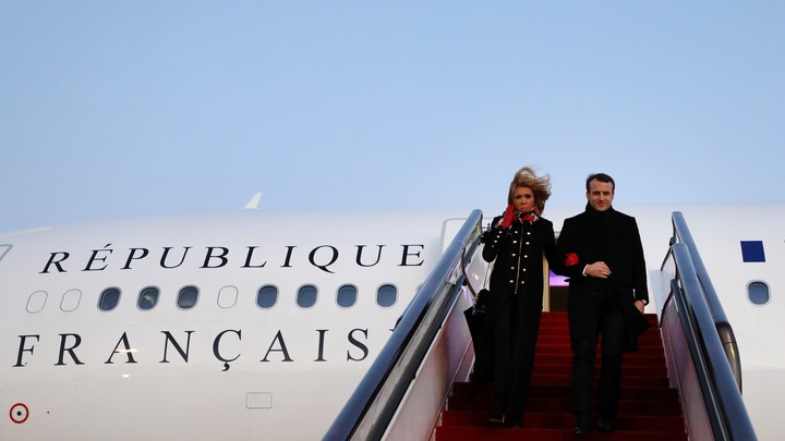 President Emmanuel Macron and his wife Brigitte Macron arrive at Beijing Capital Airport.