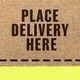 A doormat that reads, "PLACE DELIVERY HERE"