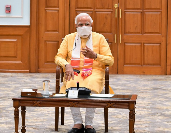 Indian Prime Minister Narendra Modi wears a face mask as he chairs a government meeting.
