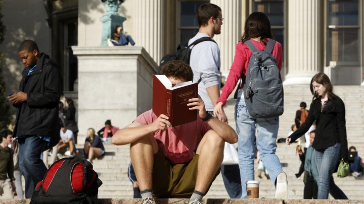 A person reads on a college campus
