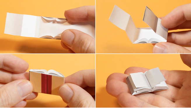 Hands fold up a tiny paper book
