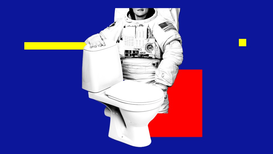 An astronaut standing next to a toilet