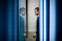 A photo of Pete Hegseth facing his reflection in a window.