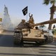Militant Islamist fighters on a tank take part in a military parade along the streets of northern Raqqa province June 30, 2014.