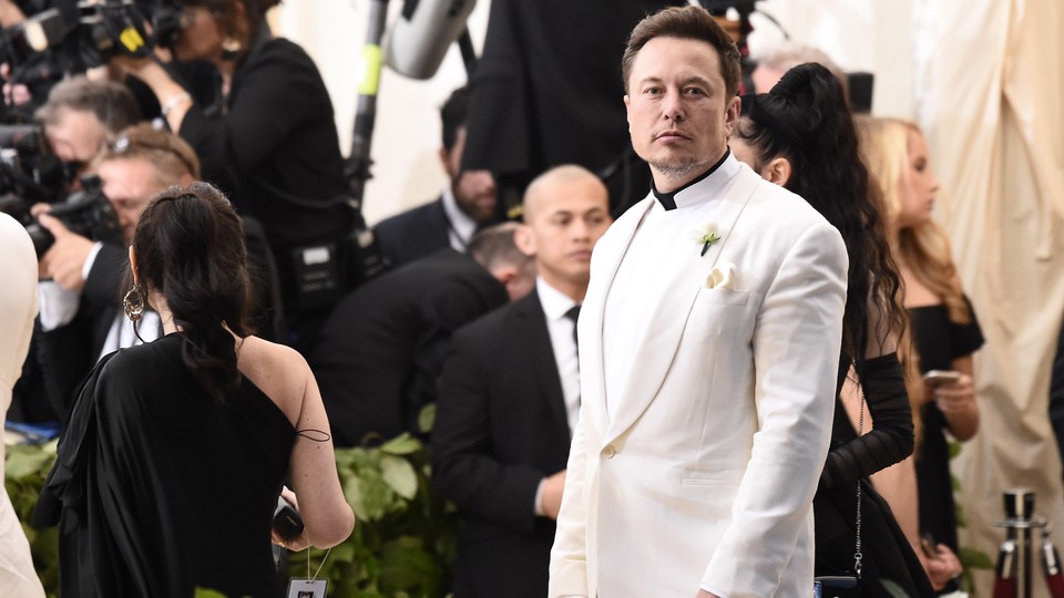 Elon Musk wearing a white suit