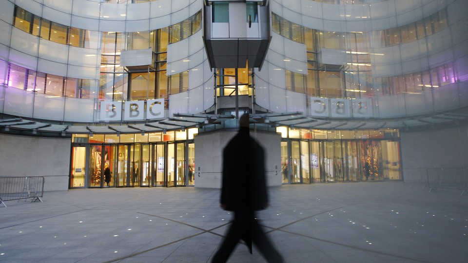 A man walks past the BBC's New Broadcasting House in London.