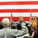 People raise their hands while oath-taking.