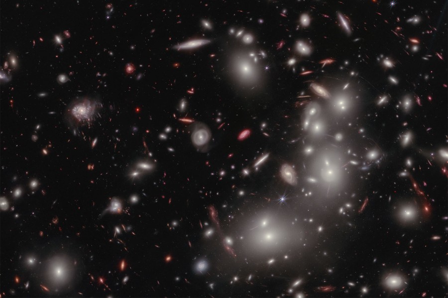 Hundreds of galaxies of varying shapes and sizes fill an image of deep space.