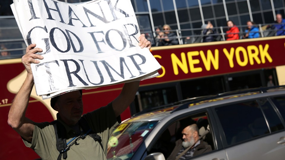 A man holds a pro-Trump sign in New York.