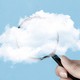 A magnifying glass half-obscured by a cloud
