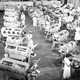 A 1950s-era black-and-white image of a large hospital room filled with at least 30 iron lungs with patients inside them