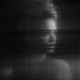 A blurry black-and-white image of a young woman