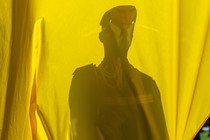 Photo of a Ukrainian soldier's silhouette against the country's flag.