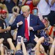 President Donald Trump gestures to the crowd before exiting a campaign rally.