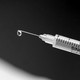 Black and white photo of a syringe