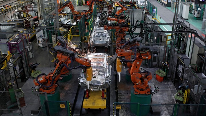Robots put together cars at a factory in France.