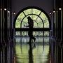 An unidentifiable man walks with a cellphone through a Capitol Hill building.