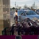 Shopping carts and two people getting into their car.
