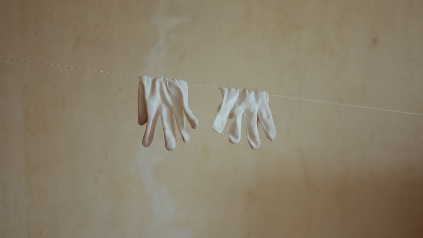 Photo of gloves hanging on a laundry line
