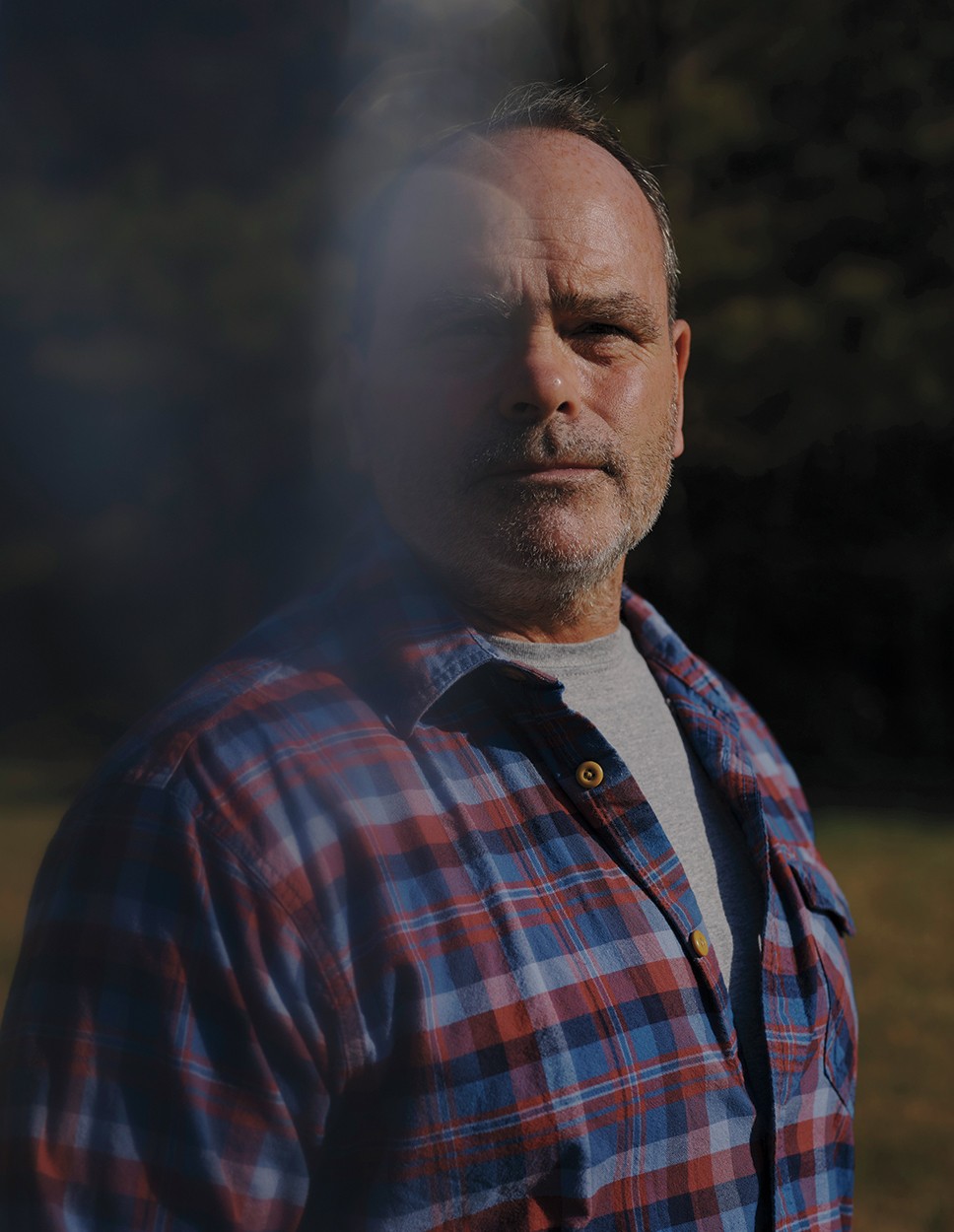photo of same man today in t-shirt and plaid button-down