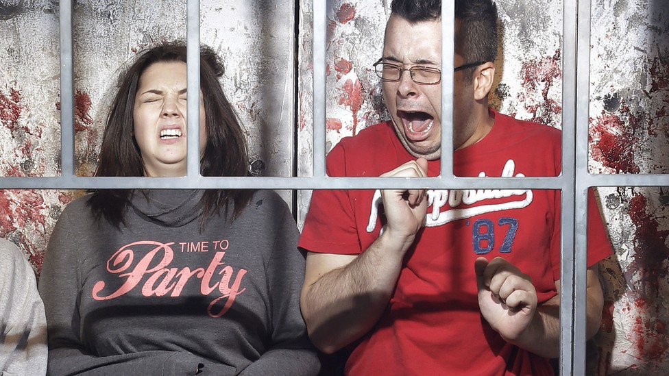 Visitors react at a haunted house.