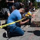 A man praying and holding flowers for the children killed in Uvalde, Texas.