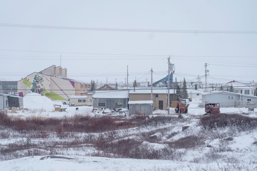 A view of the town of Churchill, many smaller buildings, outbuildings, and power poles.
