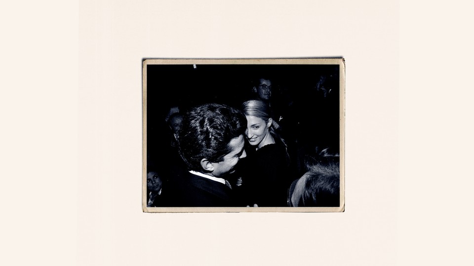 A black-and-white photo of John F. Kennedy Jr. and Carolyn Bessette, against a cream-colored background