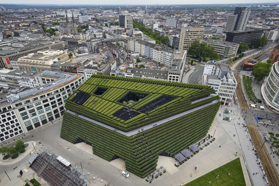 An aerial view of a new city building covered by rows and rows of hedges