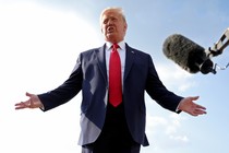 A photo of Donald Trump speaking in front of a boom microphone